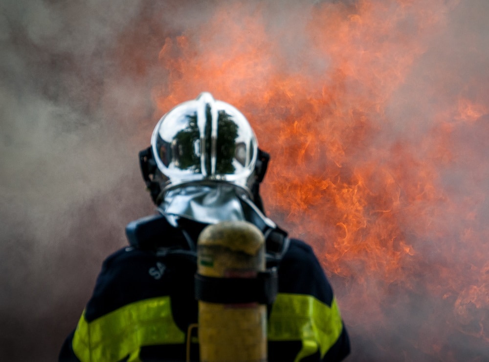 Fireman standing in front of a flaming background